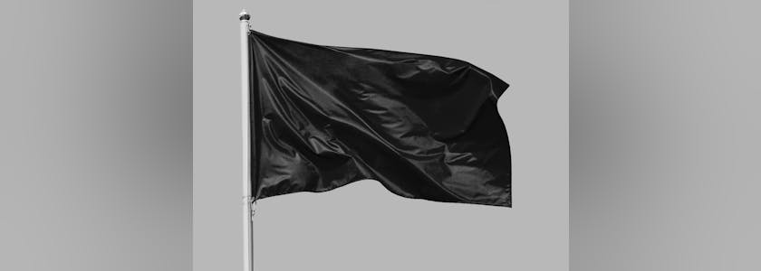 Black flag waving in the wind on flagpole, isolated on gray background