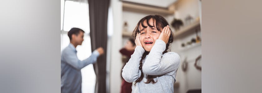 Little girl crying because of her parents quarreling. Girl abused with mother and father shouting and conflict angry background in home. Family dramatic scene, Family social issues problem concept.