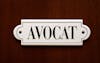 A closeup on door with lawyer name Avocat in french. Concept of lawyer services.