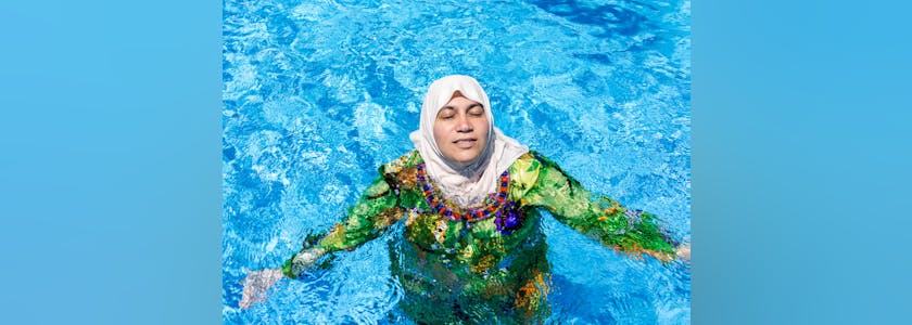 Muslim Arabic woman with burkini in pool