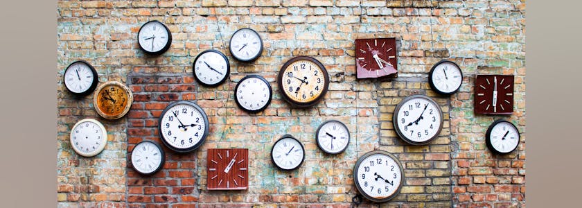 Collection of vintage clock hanging on an old brick wall