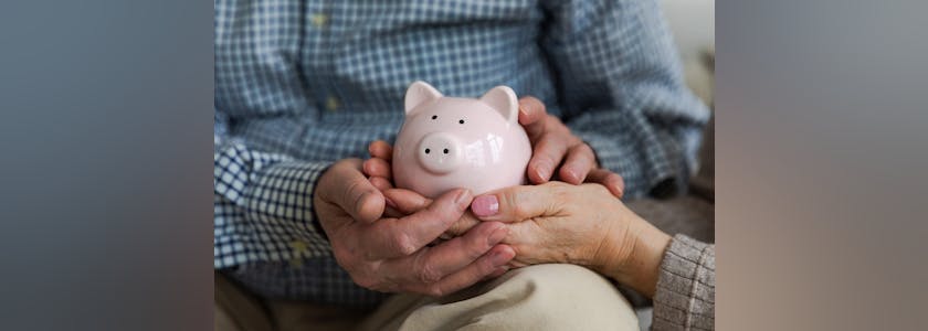 Saving money investment for future. Senior adult mature couple hands holding piggy bank with money coin. Old man woman counting saving money planning retirement budget. Investment banking concept.