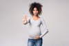 African-american pregnant woman gesturing stop to camera